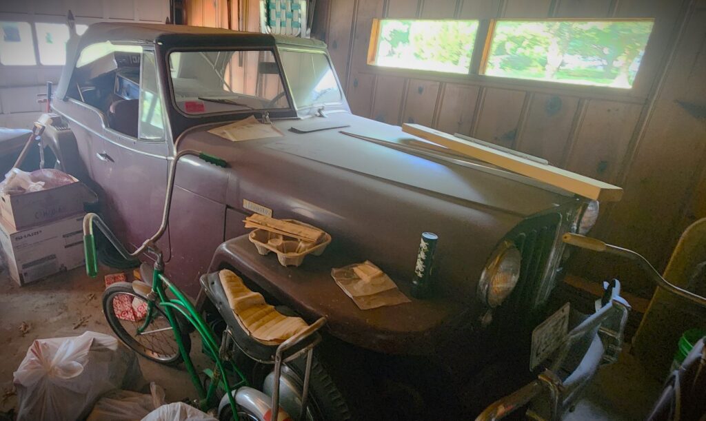 old barn find Jeepster in a garage